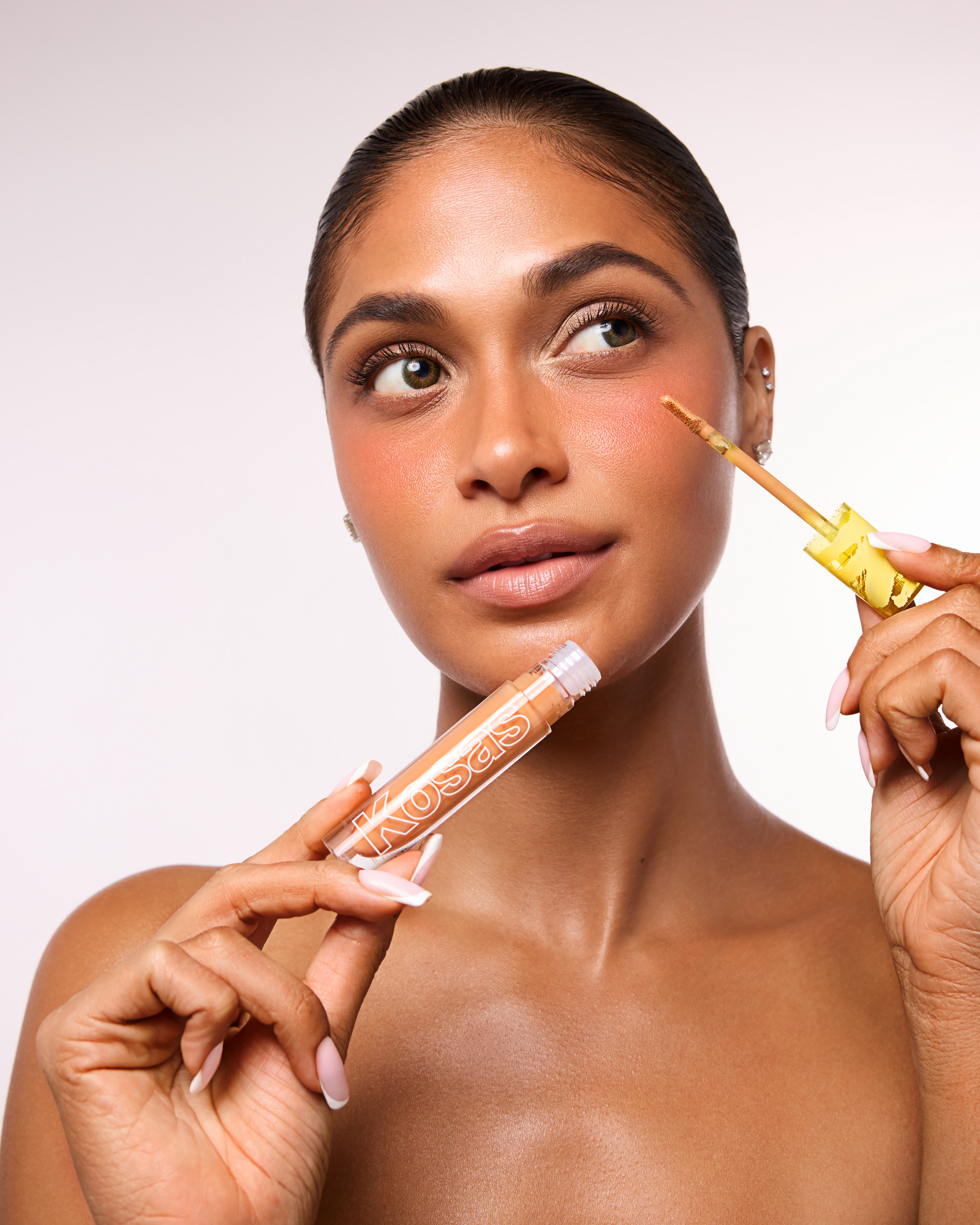 Commercial makeup retouching of beauty model showcasing cosmetics concealer product for flawless skin