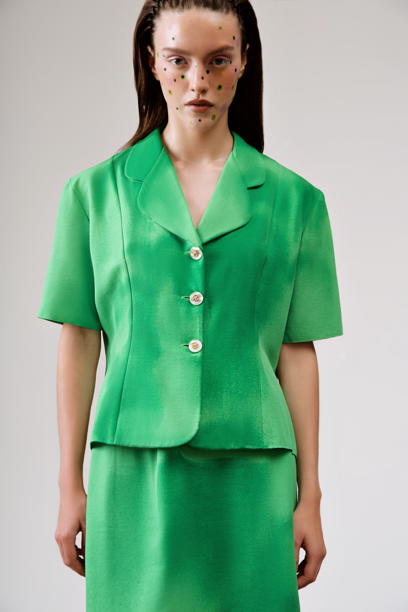 Commercial lookbook retouching for clothing brands and photographers — green tailored suit, clean studio, catalog and lookbook finish