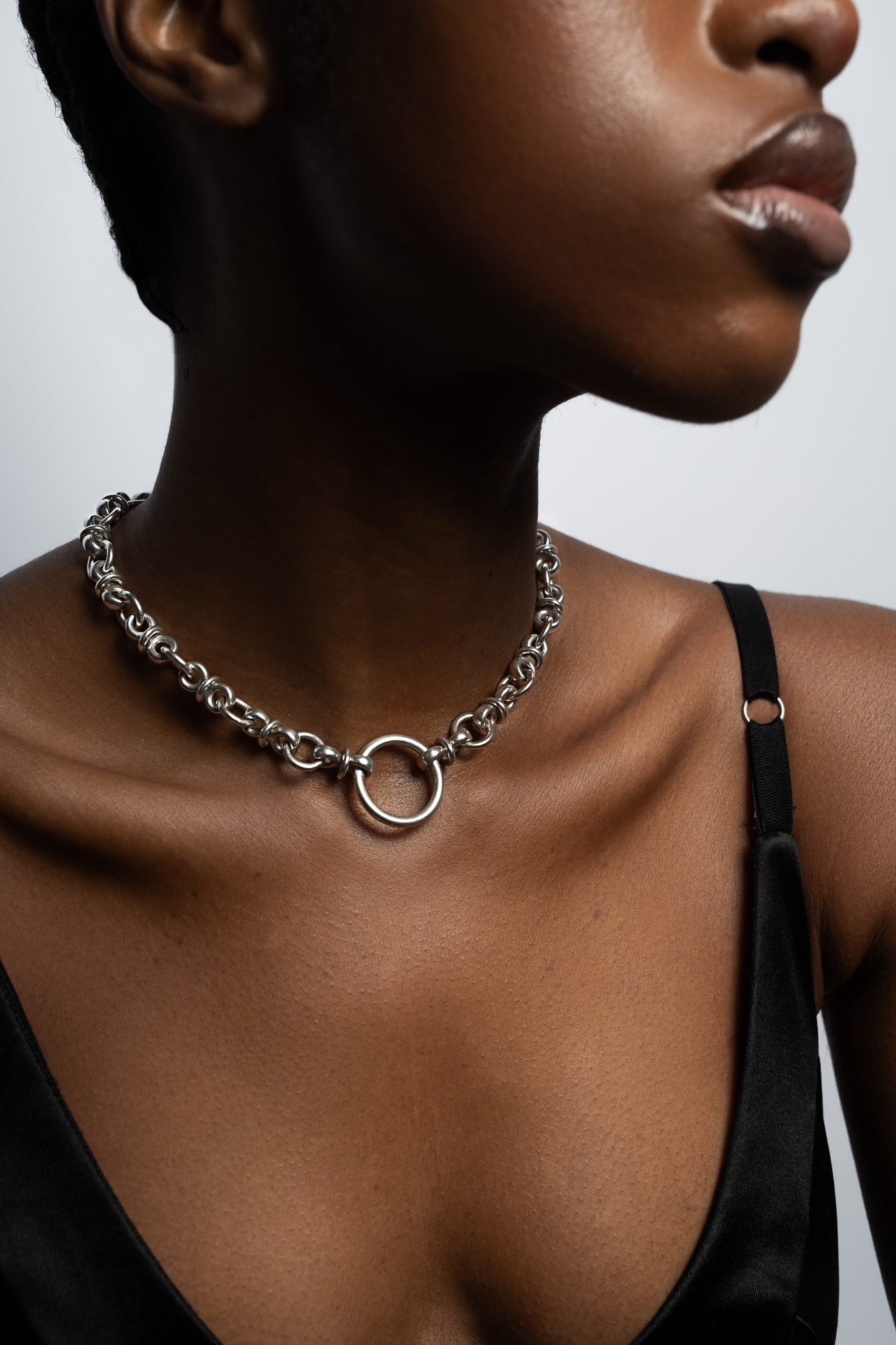 Jewelry and accessory retouching for luxury brands and photographers — silver necklace close-up, skin texture and metal detail