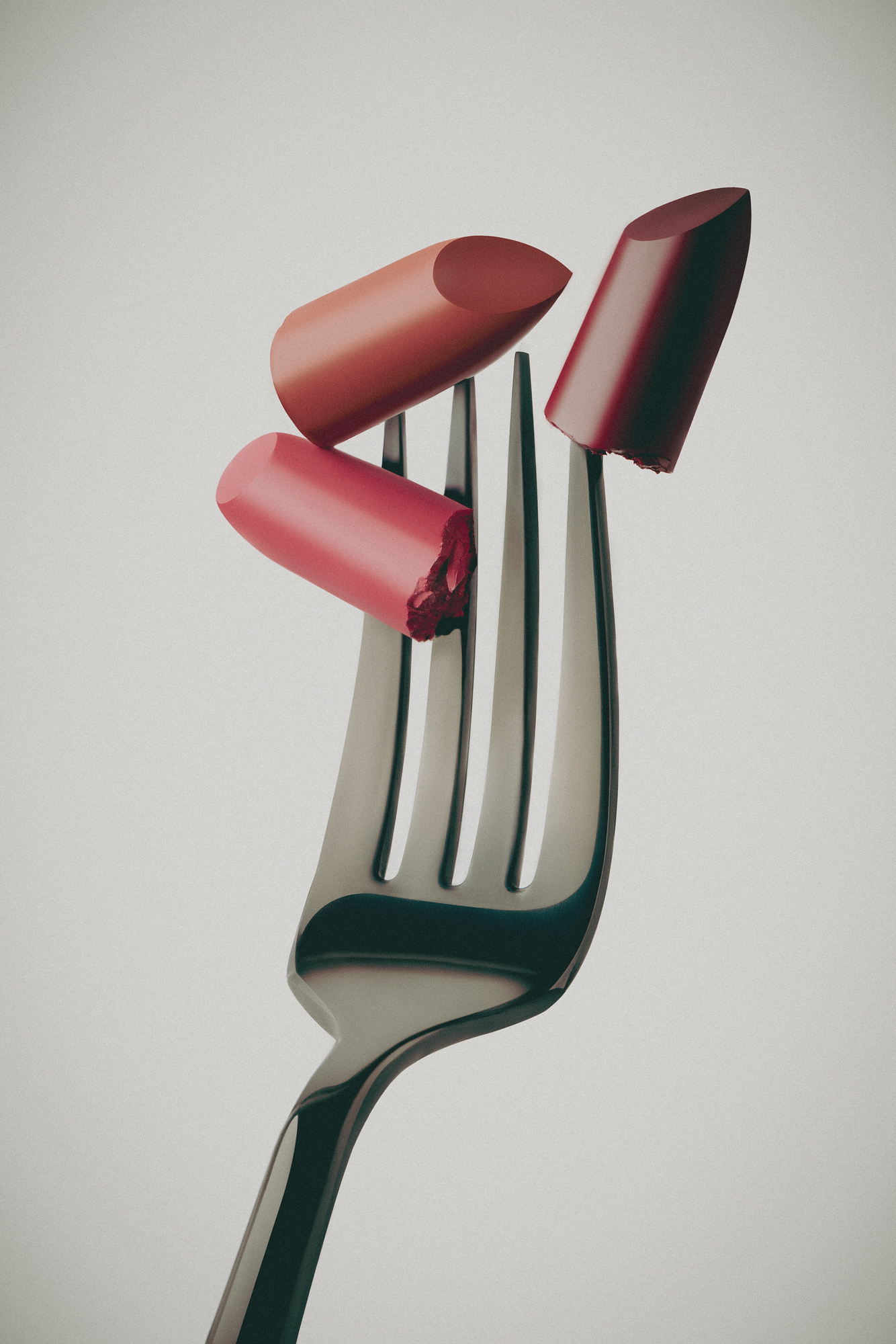 Lipstick product retouching for cosmetic brands: three lipstick bullets on a fork, color and texture still life for advertising