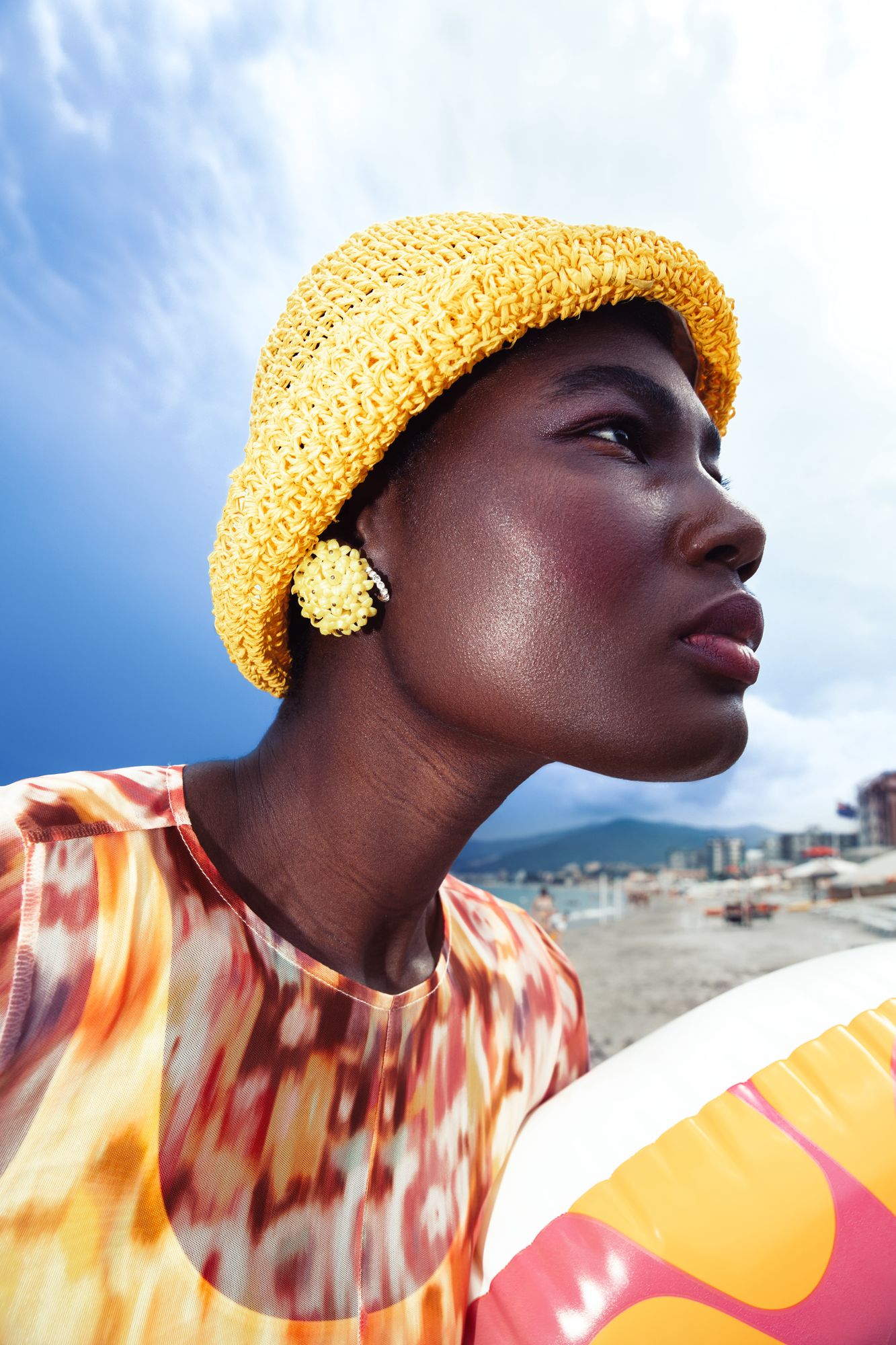 High end fashion accessory retouching portrait featuring summer straw hat and glowing skin texture correction